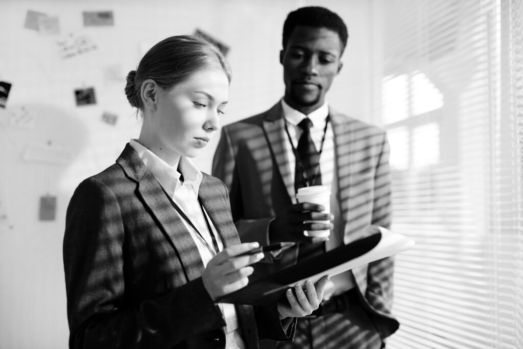 female and male investigator white room iStock-876209632_BW