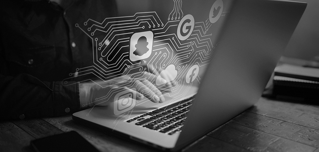 Man at laptop-socialmediaicons-circuit-iStock-1052x500
