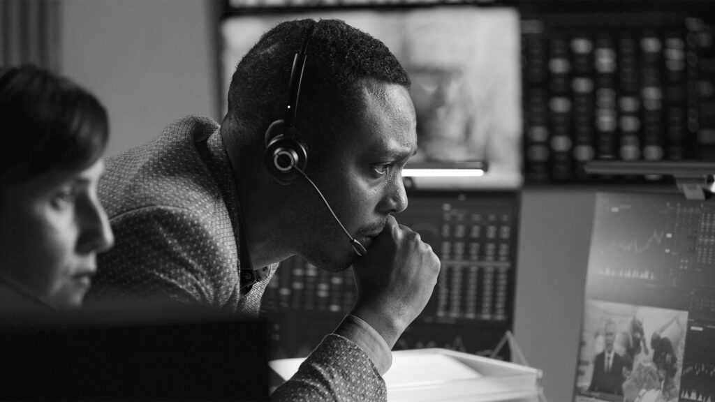 Multracial financial analysts work in bank office in late evening Multracial financial analysts work in bank office in late evening